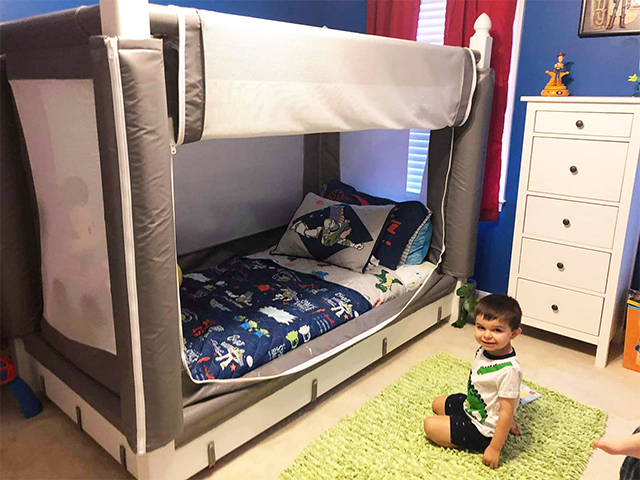 Wider room view of the gray bed